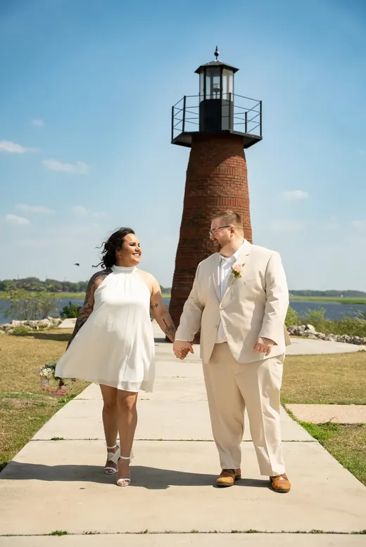 Bride and groom wedding portrait at the lakefront lighthouse